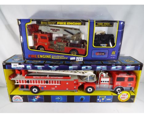 A City Force fire engine with built-in sound and light by Funrise and a remote control battery operated fire engine by Toysta