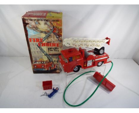 A remote control battery operated fire engine by Marx Toys, appears in excellent plus condition in excellent box