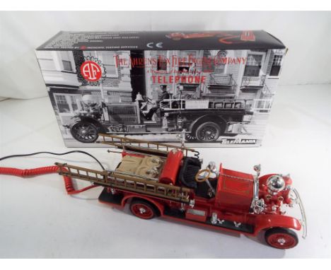 A novelty telephone in the style of a vintage Fire Engine, 'The Ahrens Fox Fire Engine Company' by TeleMania, mint in box