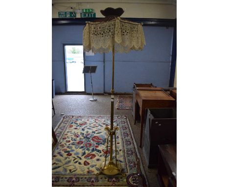Brass standard lamp with Art Nouveau style three footed base