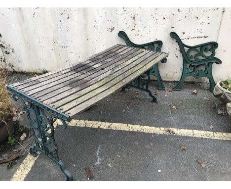 Wooden garden table with green painted metal ends, together with two pairs of green metal bench ends, table approx 140cm in l