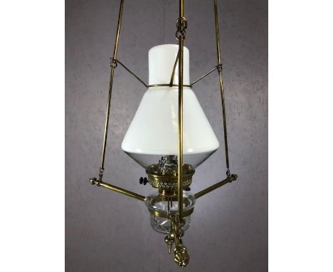Hanging oil lamp with a combination of clear and white opalescent glass, suspended in a brass weighted adjustable framework