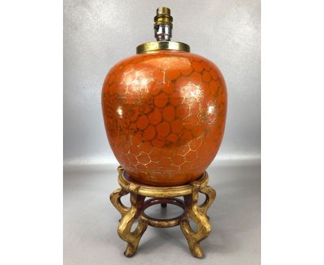 Chinese ginger jar converted to a lamp with orange ground and gold floral decoration, on wooden stand, approx 34cm in height