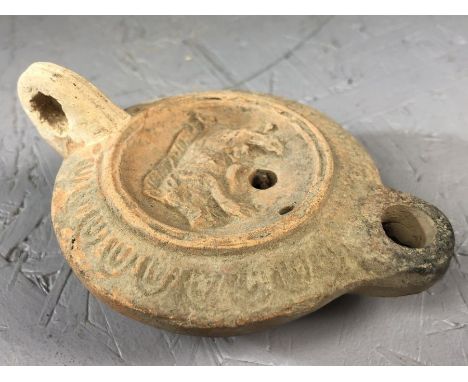 Ancient Roman terracotta oil lamp with central discus decorated with a wild bore, makers mark to base, approx 11cm x 8cm x 3c