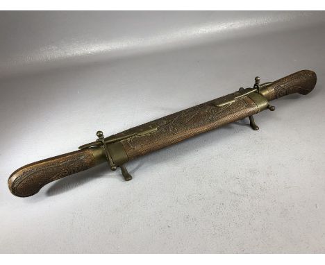 Carving set of Knife and fork in eastern design carved wooden block with brass fittings and feet