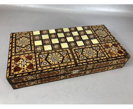 Inlaid folding backgammon set with backgammon pieces in an inlaid Middle Eastern design, approx 40cm x 20cm x 16cm