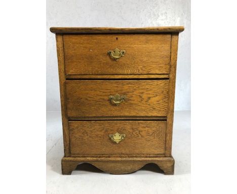 Light oak chest of three drawers with brass handles, approx 65cm x 39cm x 80cm tall