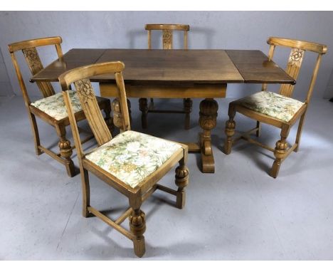 Extendable dining table of carved light oak with heavily carved legs and two integrated leaves, unextended approx 94cm x 73cm