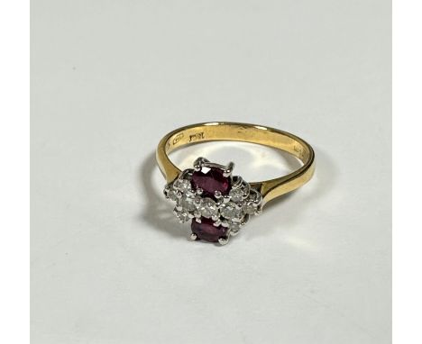 An 18ct yellow gold two stone ruby and diamond cluster ring, approximately 0.04ct, set nine diamonds, all mounted in claw set