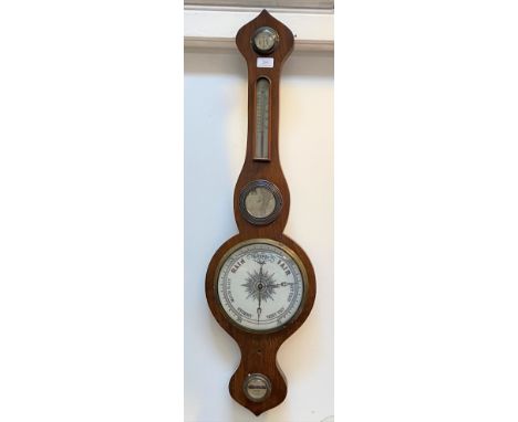 A late 19th century oak cased mercury barometer and thermometer in a banjo pattern case, the white ceramic and silvered regis