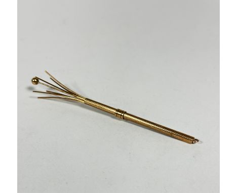 A 9ct gold engine turned decorated swizzle stick