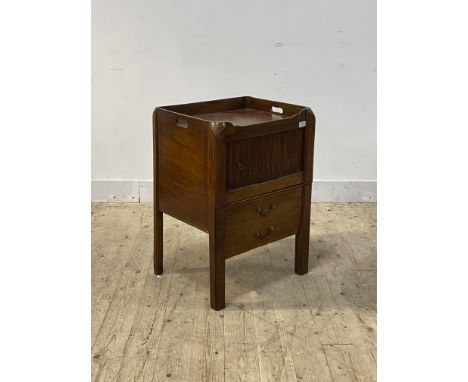 A George III mahogany night commode or bedside table, the tray top with pierced handles over tambour cupboard and drawer to b