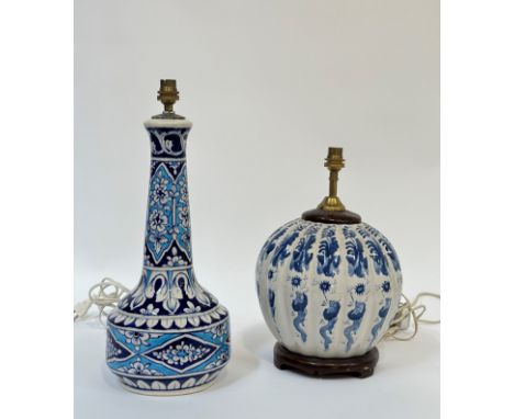 A pair of ceramic lamp bases, one Chinese blue and white with design of dragons and phoenix (h- 34cm), the other middle easte