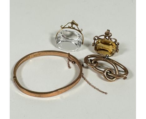 A 9ct gold child's stiff hinged bangle complete with safety chain, dented (3.8g) a 9ct gold open work scroll brooch set three