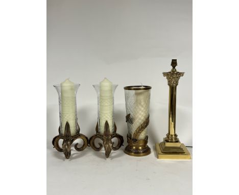 A pair of modern storm lanterns with slice cut banded glass raised on fern style scroll triple supports (h- 37cm) and a lacqu