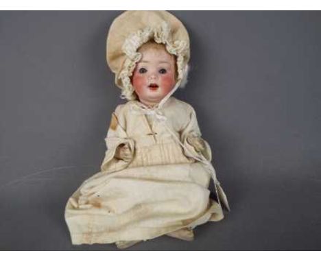 Porzellanfabrik Mengergereuth - a ceramic faced doll with sleeping blue eyes, open mouth showing teeth with a jointed arms an