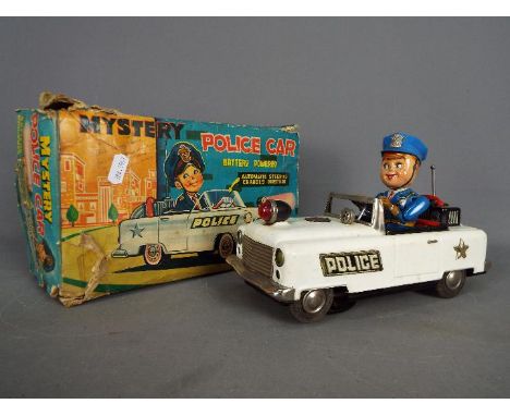 Nomura (TN Toys of Japan)  - A boxed battery operated tinplate Mystery Police Car by Nomura (TN Toys), measuring approximatel