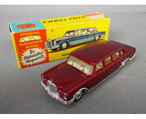 Corgi - A boxed Corgi #247 Mercedes 600 Pullman. The model with metallic red body, off white interior, chrome trim, with spun