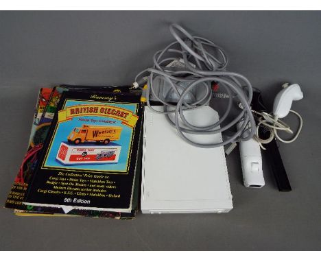 A Nintendo Wii games console and accessories, a small quantity of comics and a Ramsay's Collector's Price Guide 9th Edition. 