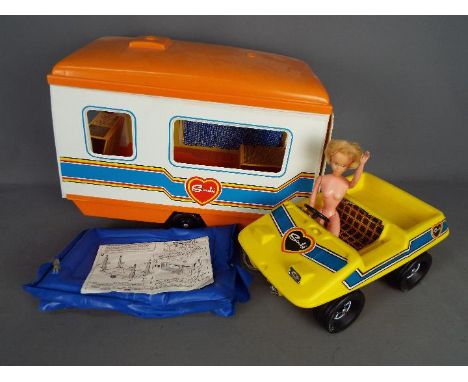 Pedigree - An unboxed vintage Sindy caravan and buggy by Pedigree with an an unmarked naked doll. Lot also includes an instru