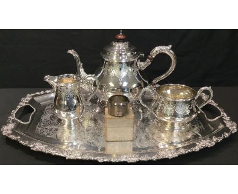 A silver napkin ring, engine turned, Birmingham 1918, 12.8g, boxed; an EPNS three piece tea service on a two handled tray (5)