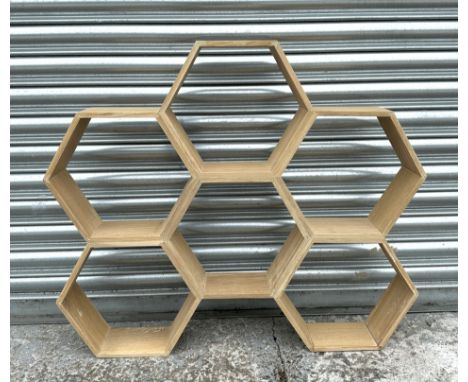 A set of honey comb style wall shelves.