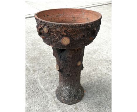 A large terracotta planter in the form of a tree stump, 94cm high, 56cm diameter