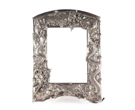 A Chinese silver plated photo frame decorated with embossed scrolling dragons and other mythical beasts, 28cm wide, 36cm high