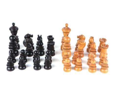 A large boxwood and ebonised chess set; together with a matching set of draughts. 