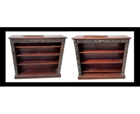 A pair of Victorian mahogany open bookcases, the frieze and sides decorated with applied carved oak depicting foliate scrolls