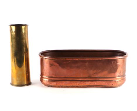 A copper planter, 43cm wide; together with a brass shell case, 29cm high (2). 