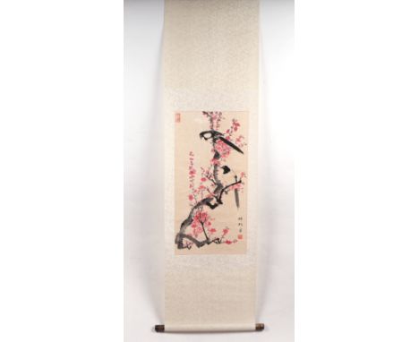 A Chinese scroll painting depicting magpies within prunus, 152cm long.