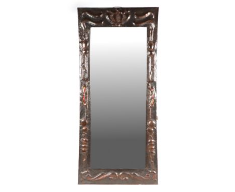 An Arts &amp; Crafts rectangular copper wall mirror in the manner of Liberty, with repousse and enamel decoration, 92cm high.