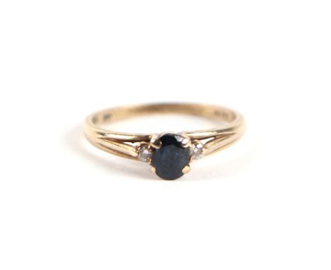 A 9ct gold sapphire and diamond ring, the central sapphire flanked by diamonds, approx UK size 'L', 2g.