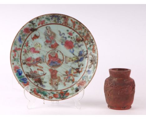 A Chinese Canton Export famille rose plate decorated with figures and precious objects, on a celadon ground, blue mark to the