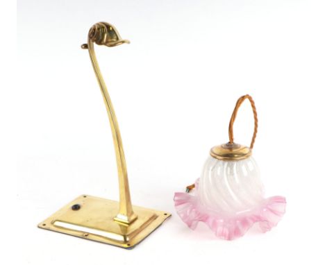 in the manner of WAS Benson, an Arts and Crafts brass wall lamp with sinuous arm and scallop shell terminal, supporting a pin
