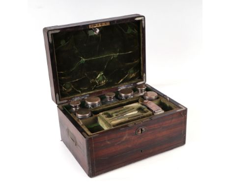 A George III coromandel dressing box retailed by T Briggs, the fitted interior with an assortment of silver topped jars to in