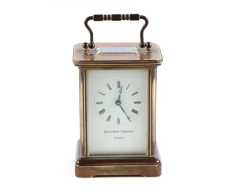 A four pillar brass carriage clock, the white enamel dial with Roman numerals, signed 'Matthew Norman, London', 12cm high. 