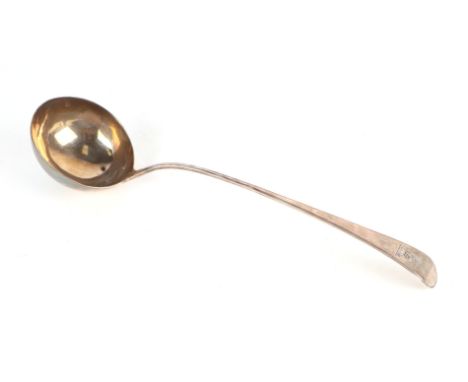 A George III silver ladle engraved with a family crest, indistinct London hallmark, 35cm long, 166g.