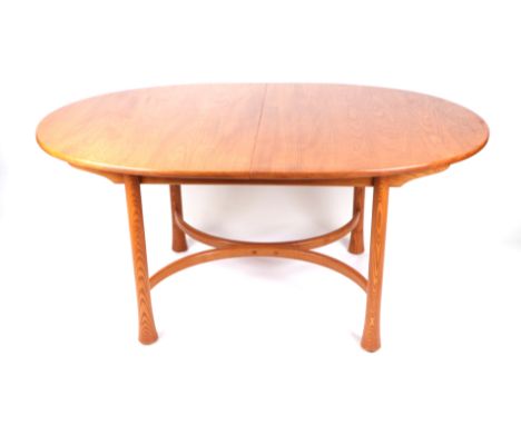 An Ercol elm oval extending dining table on turned legs with  shaped stretcher, 108cm by 162cm not extended. 