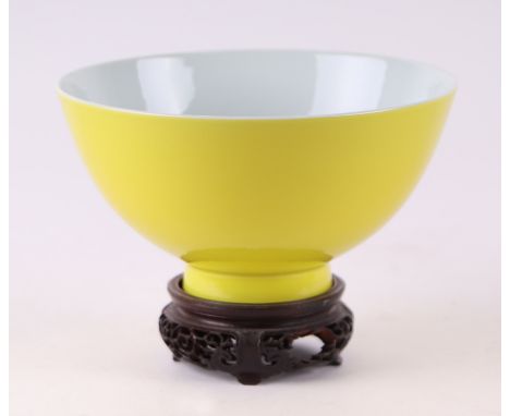 A Chinese Imperial yellow footed bowl with blue seal mark to the underside, on pierced hardwood stand, 15cm diameter. 