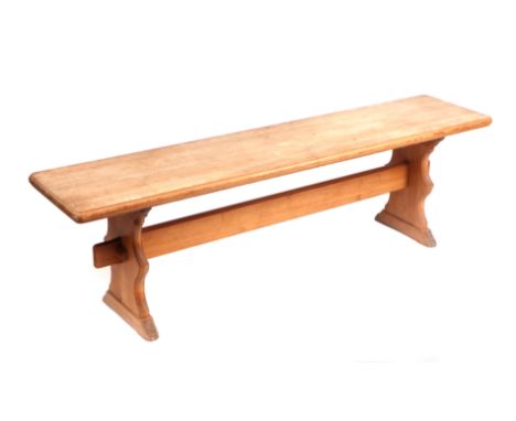 A modern pine bench, on shaped end supports joined by a stretcher. 150cm wide
