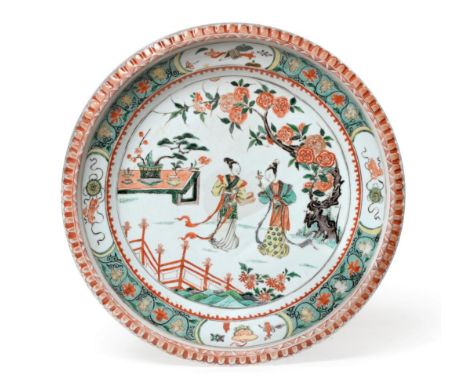 A Chinese Porcelain Charger, Kangxi, painted in famille verte enamels with figures in a fenced garden, 34cm diameter See illu