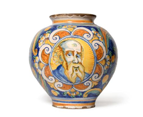 A Caltageroni Majolica Drug Jar, 17th century, of ovoid form, painted with a bust portrait of a bearded man on a foliate back