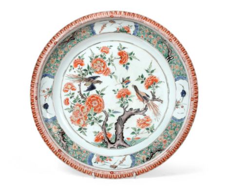 A Chinese Porcelain Charger, Kangxi, painted in famille verte enamels with a birds amongst flowering branches within a foliat