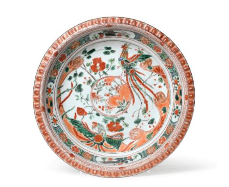 A Chinese Porcelain Plate, Kangxi, painted in famille verte enamels with a phoenix amongst foliage within a foliate border 24