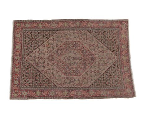 Fine Senneh Rug Iranian Kurdistan, circa 1900 The ivory and rose pink Herati field enclosed by charcoal spandrels and meander