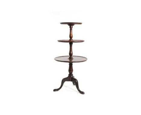 A George III mahogany dumb-waiter, third quarter of the 18th century, with three graduated platforms with a ring-turned colum