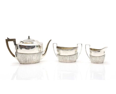 A three piece silver tea service by Samuel Walton Smith, 1895 and 1896, comprising a teapot , 27cm wide, a twin-handled sugar