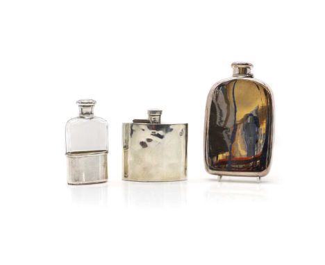 A group of three silver hip flasks comprising a large hip flask, by Tiffany &amp; co, marked sterling silver, 16.5cm high, an